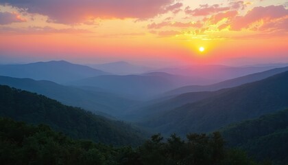 Hazy mountain range at sunset with orange pink sky. Layers of blue ridges stretch to horizon. Green forests cover rolling hills. Scenic overlook view.