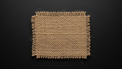 Small square burlap fabric on a dark black background