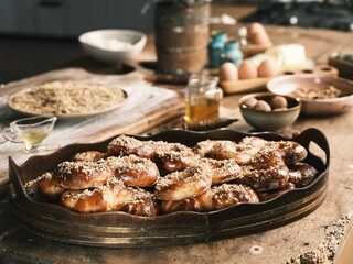 In a cozy kitchen, freshly baked treats rest on a wooden tray, adorned with a sprinkle of sweet toppings. Surrounding ingredients hint at delicious recipes being crafted with love