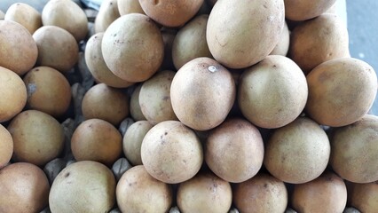 Sawo or Sapodilla Fruits Stacked in Market Display Indonesia