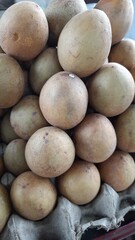 Sawo or Sapodilla Fruits Stacked in Market Display Indonesia