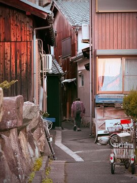 Elderly Japanese woman walking through a traditional old street