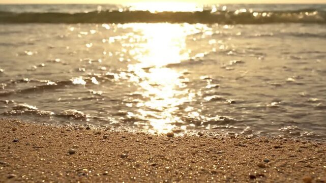 Golden Hour Shoreline Radiance beach sparkle summer A tranquil medium shot of the empty beach shoreline during late afternoon golden