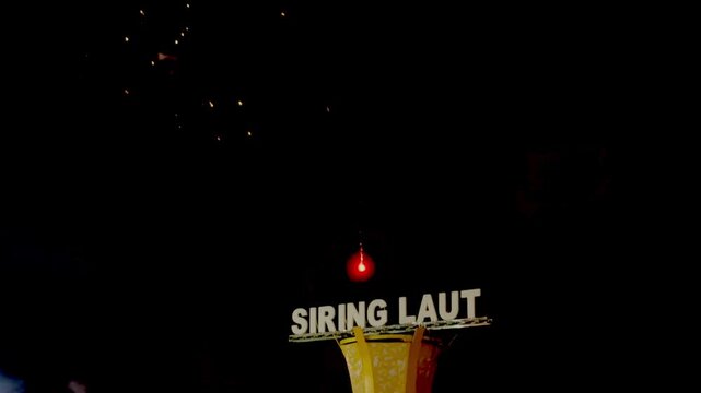 Night fireworks lit up the dark sky above an iconic building on the "Siring Laut" beach in Kotabaru Regency, South Kalimantan Province, Indonesia.