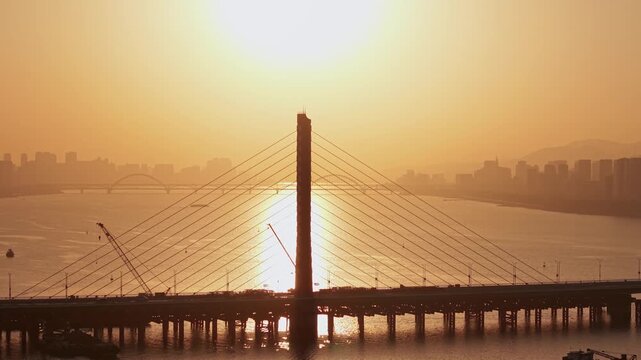 Aerial view of Hangzhou Qiantang river bridge at golden hour sunset with city skyline