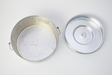 Vintage embossed aluminum container with floral pattern on white background