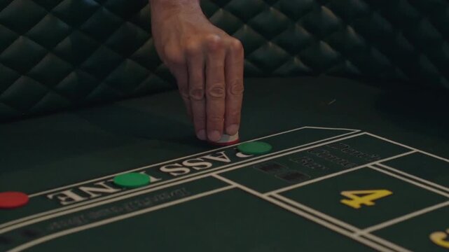 Close Up of Hands At Casino Craps Table Placing Bet