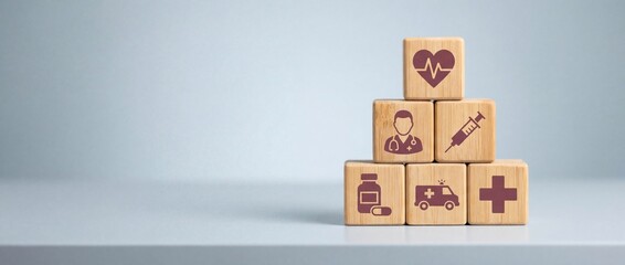 Pyramid of six light bamboo blocks with medical icons symbolizing healthcare concepts