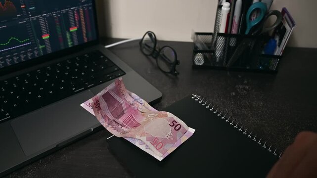 Businessmen counts Qatar money bills on hand, which is called Riyal. Paper banknotes of various denominations