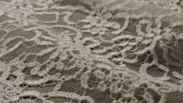 Close Up of White Lace Material Rolling