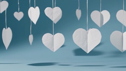 Floating Heart Shapes in Air Above Soft Blue Surface