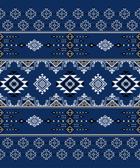 Seamless geometric ethnic pattern in deep blue tones with symmetrical tribal motifs.