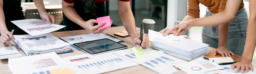Collaborative business team analyzing financial data charts and statistics on office desk during a...
