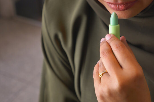 woman applying lip bum closeup 