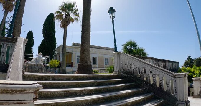 Tourist pov on stairs sightseeing the Achillion Palace situated on the island of Corfu, Greece