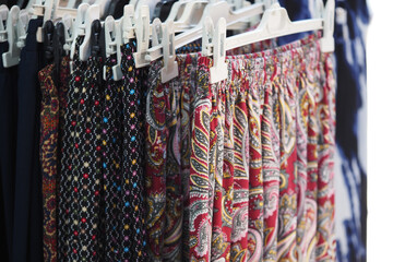 Colorful skirts hanging on display in a shop