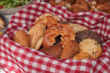 Fresh baked goods in a basket with red checkered cloth