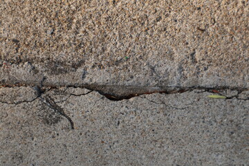 Close-up of a Horizontal Crack Dividing Rough Aggregate and Smooth Concrete Surfaces
