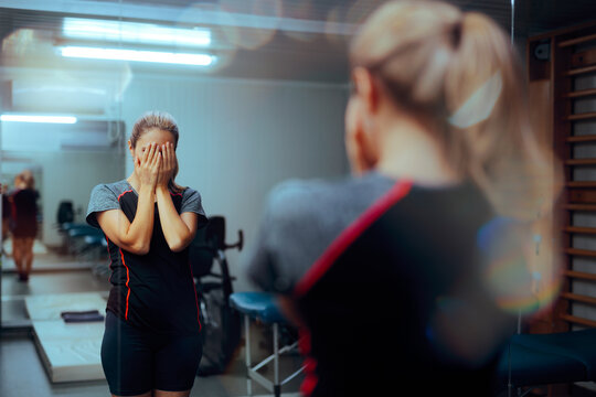 Woman Suffers from Body Dysmorphia in a Gym Feeling Anxious. Stressed and unhappy person with low self esteem and many insecurities