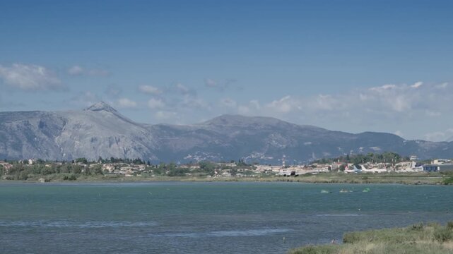 Aircraft take off high above rocky mountains from Corfu International Airport. Corfu island, Greece, slow motion