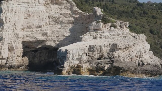 Pov boat sail with view of amazing rocky coastline of Paxos island in Greece