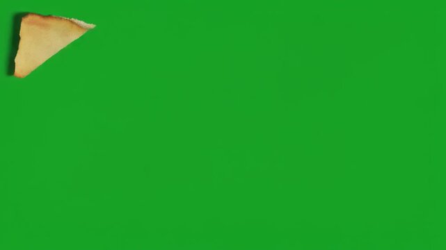 Old torn paper texture with burnt edges on a green screen background.