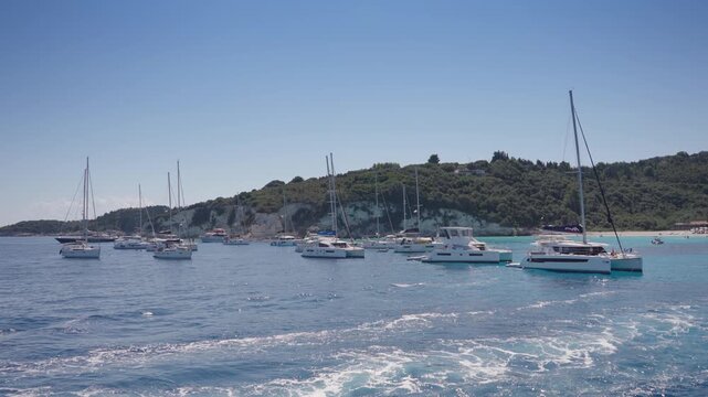 Sailing at iconic tropical paradise beaches of Voutoumi and Vrika with turquoise clear sea, Antipaxos island, Ionian, Greece
