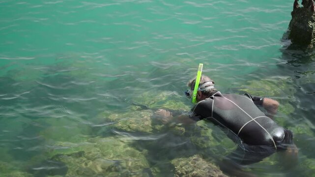 Spear fishing gun scuba diver in tropical exotic sea