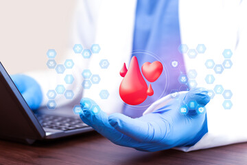 A doctor analyzes blood donation data on a laptop. Concept of blood supply, transfusion management, and modern digital hematology. Doctor displays blood test results and a heart icon.