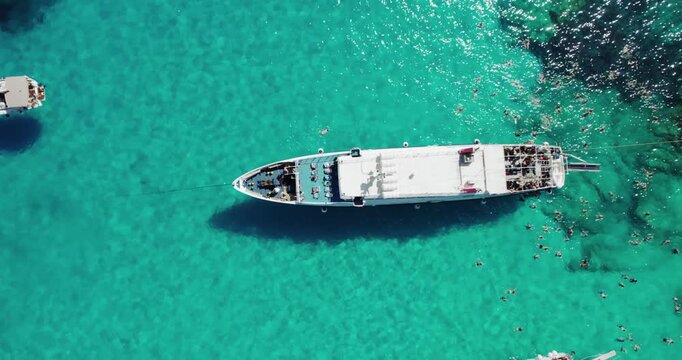 Aerial drone view of luxury yacht boats at the breathtaking Voutoumi beach, Antipaxos Greece