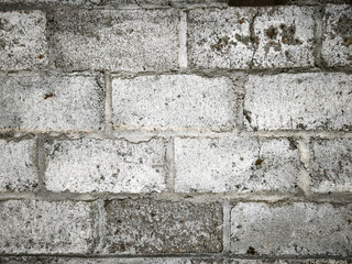 Obraz premium A high-resolution texture of a weathered concrete block wall with visible mortar lines and rough gray surfaces, perfect for industrial backgrounds, architectural design, and urban construction.