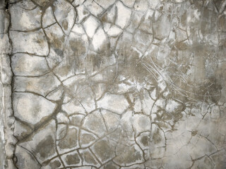 A high-detail texture of a cracked concrete surface featuring intricate spider-web patterns and...