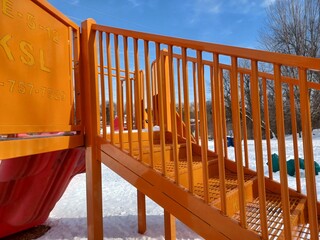 Empty children playground covered in snow