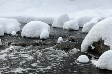 Obraz premium Snow-Covered Rocks in Creek