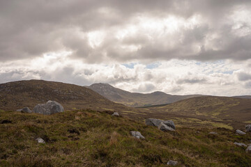 A cloudy day with a mountain in the background. The sky is overcast and the mountains are in the distance