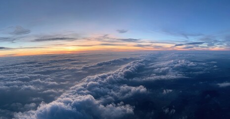 Fototapeta premium Panoramic view of clouds from an airplane at sunrise