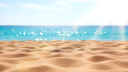 Close up of sandy beach with ocean waves in the background on a sunny day with clear blue sky and sea water reflecting sunlight with tropical