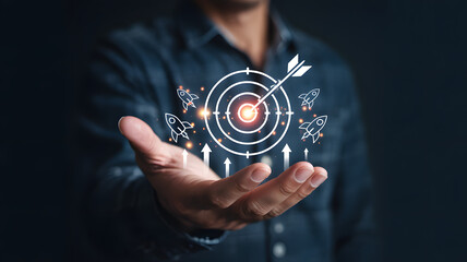 Businessman presenting target with rockets and arrow in hand
