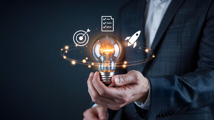 Businessman holding glowing light bulb with innovative ideas