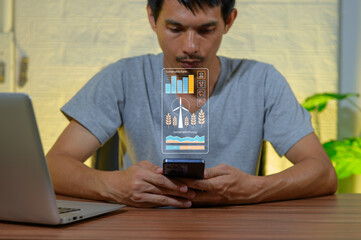 Man Using Smartphone with Sustainability Technology Displayed