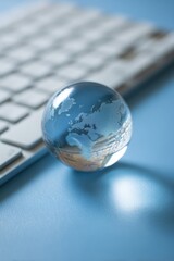 Transparent globe resting on a keyboard