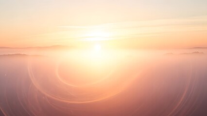 Abstract sunrise landscape with golden mist and glowing sun over distant mountains