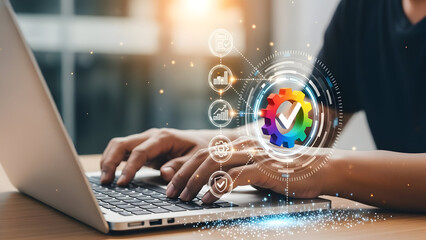 Businessman working on laptop with futuristic technology icons floating above keyboard.