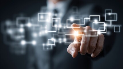 Close-up of a person in a suit pointing at an illuminated digital interface with glowing squares and lines, suggesting interaction