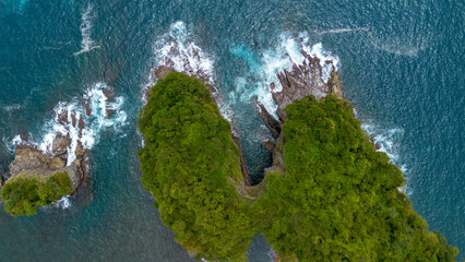 Aerial view of tropical islands and turquoise sea with lush green forest in South Malang