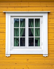 Close-up of a white-framed window on a vibrant yellow wooden wall