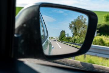 Car rearview mirror showing nature