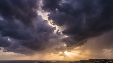 Dramatic storm clouds with rays of light breaking through over a landscape