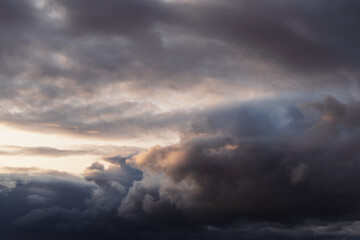 Dramatic storm clouds with sunset light