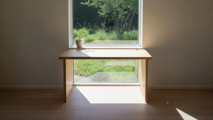 Modern wooden desk positioned beneath large window with natural garden view and potted plant in minimalist interior space